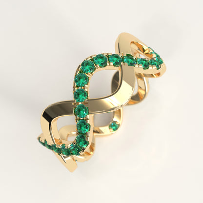 Close-up of interlocking yellow gold bands with round Colombian emeralds, Weave Ring by GOHI Endless Collection