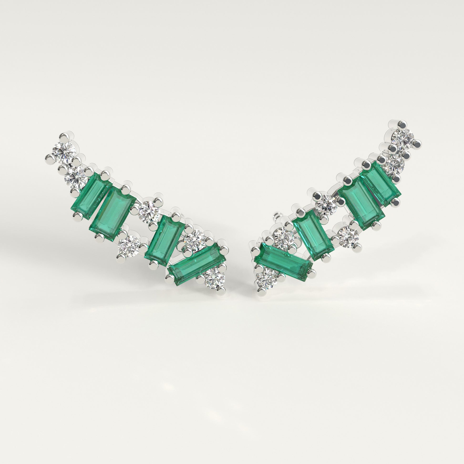 Front view of Rise Earrings — Colombian emerald dominant ear climbers with round diamonds in 18k white gold, GOHI Fault Line