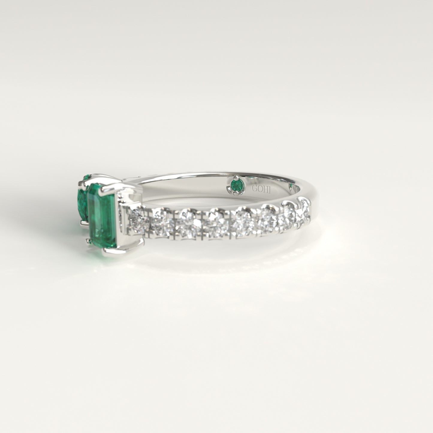 lateral of round and emerald-cut Colombian emeralds on open toi et moi ring, Duet Ring by GOHI Soiree Collection