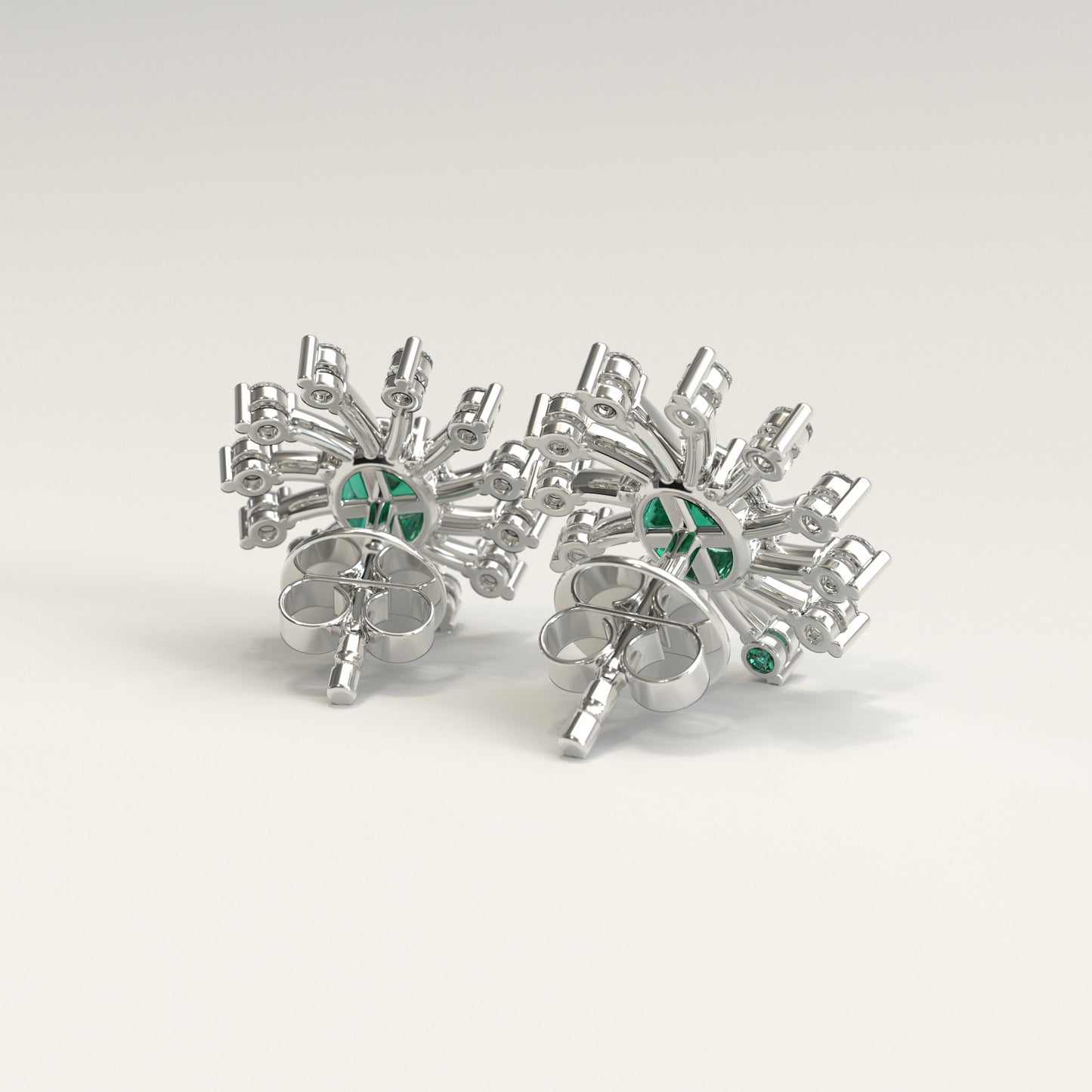 Back view of Nova Earrings showing hidden Colombian emerald beside GOHI signature, 18k white gold.